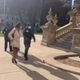 Armed escorts walk Michigan State Rep. Sarah Anthony into the state capitol building.